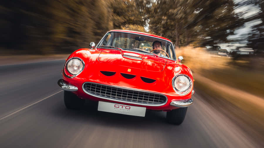 Experience The Art Of Driving A Vintage Ferrari Wallpaper