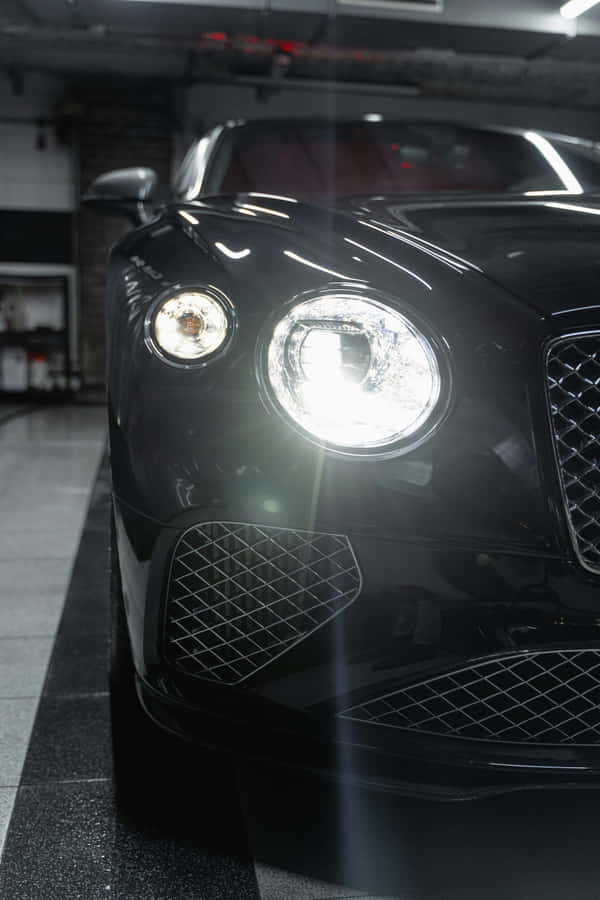 Gleaming Black Luxury Car Front View Wallpaper
