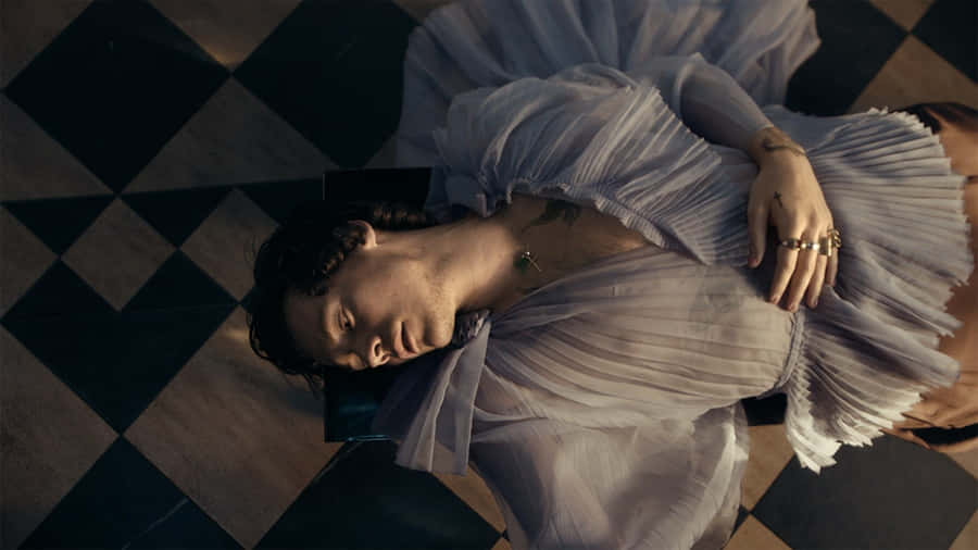 Harry Styles Enjoying His Laptop In His Home Wallpaper