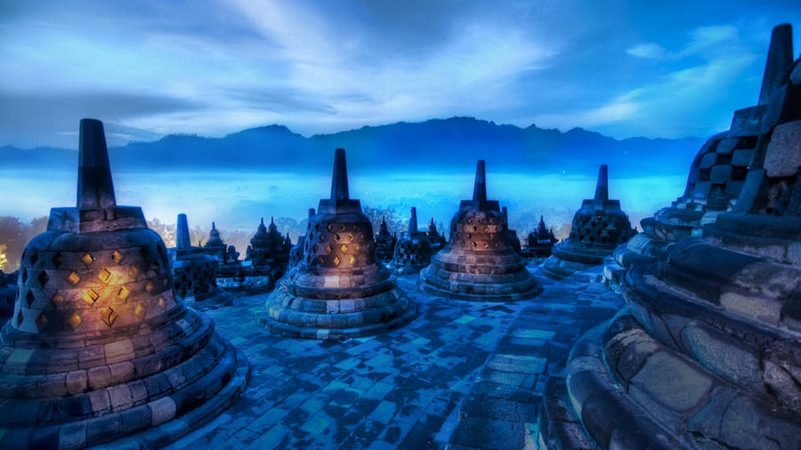 Download Borobudur Temple At Night With Fog And Mountains Wallpaper |  Wallpapers.com