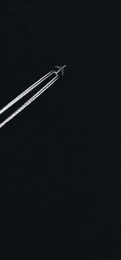 Jet_ Contrail_ Against_ Dark_ Sky Wallpaper