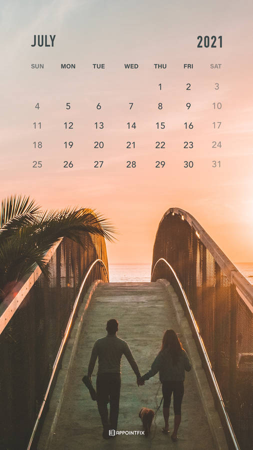 July 2021 Calendar With Two People Walking On A Bridge Wallpaper