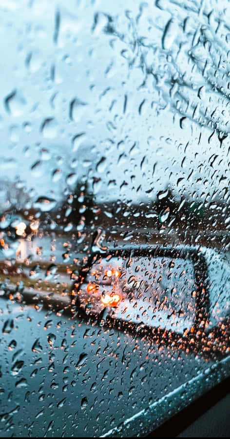 Listen To The Sound Of The Rain Amidst A Vibrant Cityscape Wallpaper