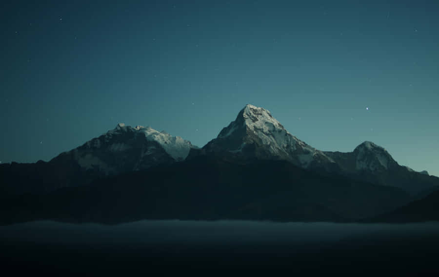 Majestic Mountain Scenery Fills The Sky Wallpaper