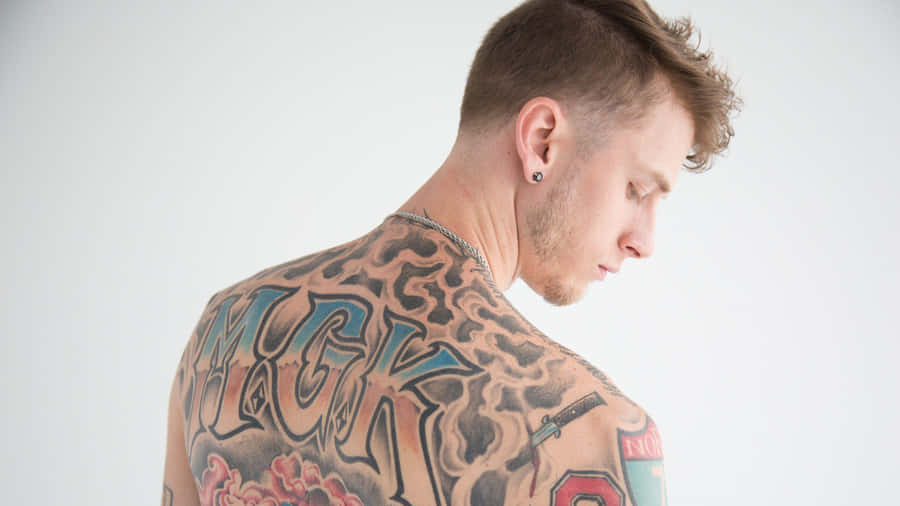 mgk showing his back