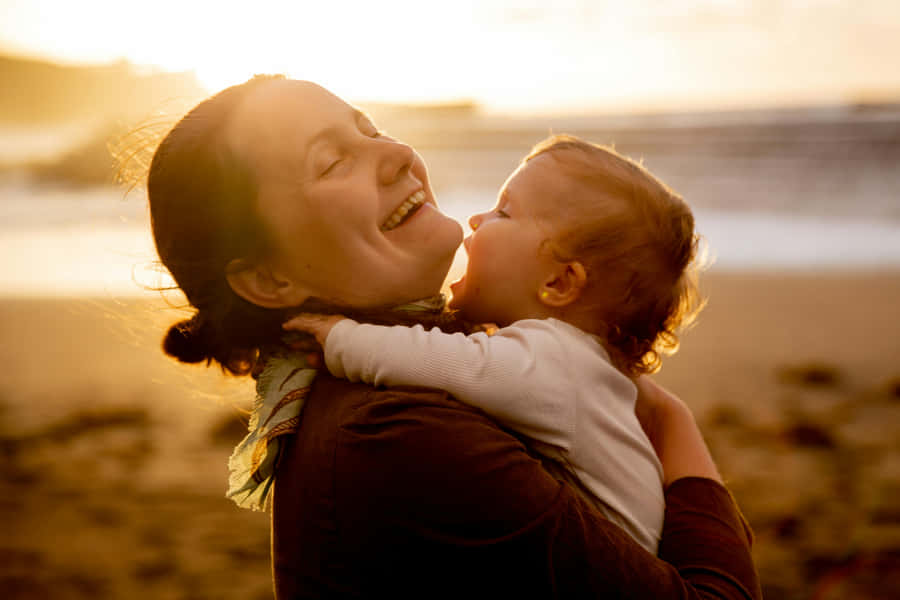 Mother Child Sunset Embrace Wallpaper