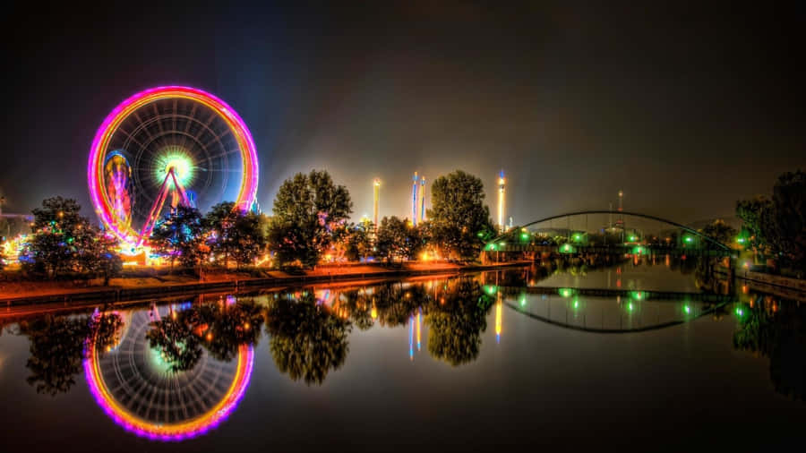 Nighttime Ferris Wheeland Reflections Wallpaper