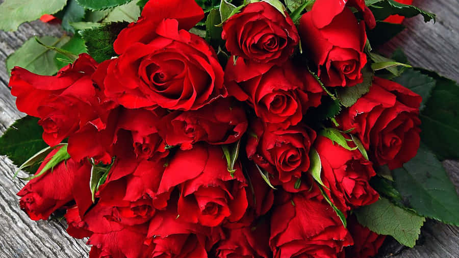 Red Roses Laptop Laid On A Wooden Surface Wallpaper
