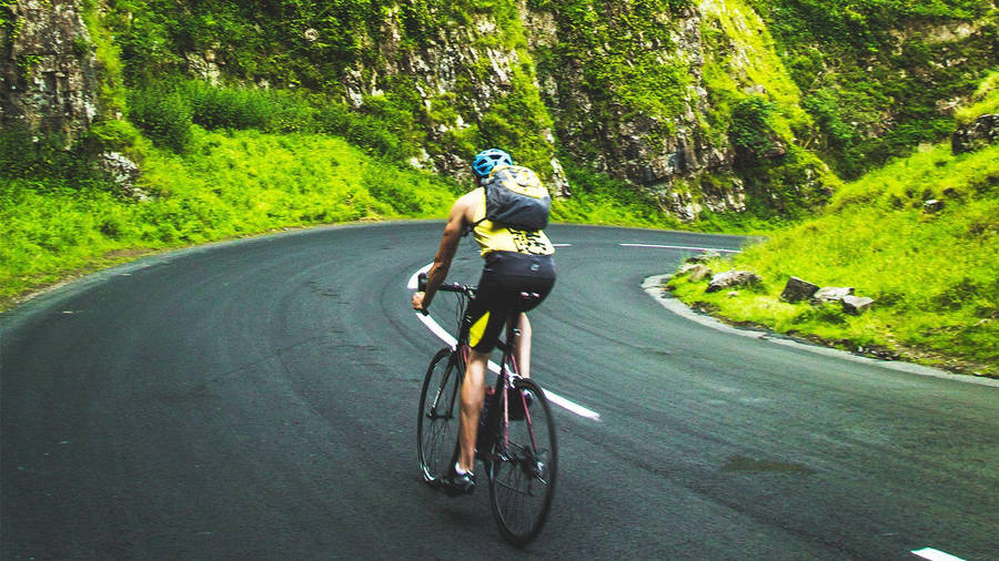 Road Bike Mountain Side Riding Wallpaper