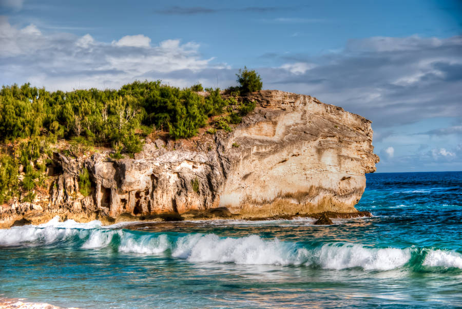Rocky Cliff And Sandy Beach Wallpaper