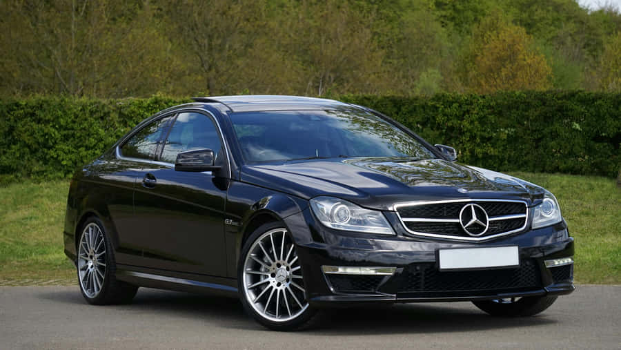 Sleek Black Mercedes Coupe Parked Outdoors Wallpaper
