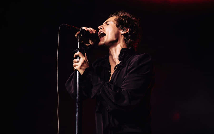 The Iconic Harry Styles In A Captivating Black And White Portrait. Wallpaper