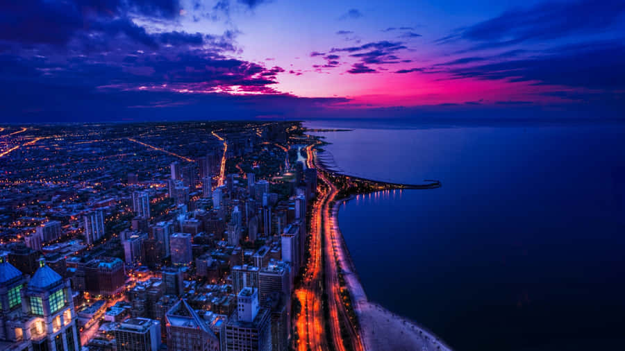 The Night Sky Tremendously Lights Up A Vast City Wallpaper