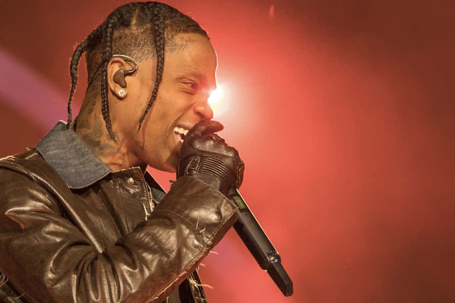 Travis Scott Giving An Electrifying Performance At His Concert Wallpaper