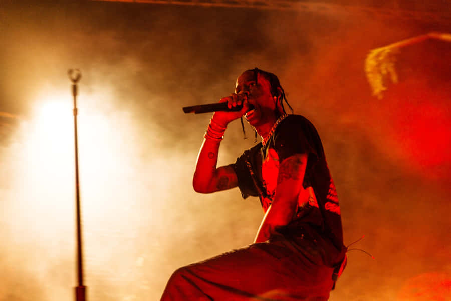 Travis Scott Pumping Up The Crowd In A Recent Concert Wallpaper