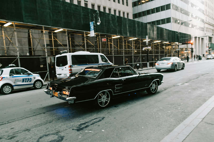 Vintage Black Muscle Car City Street Wallpaper