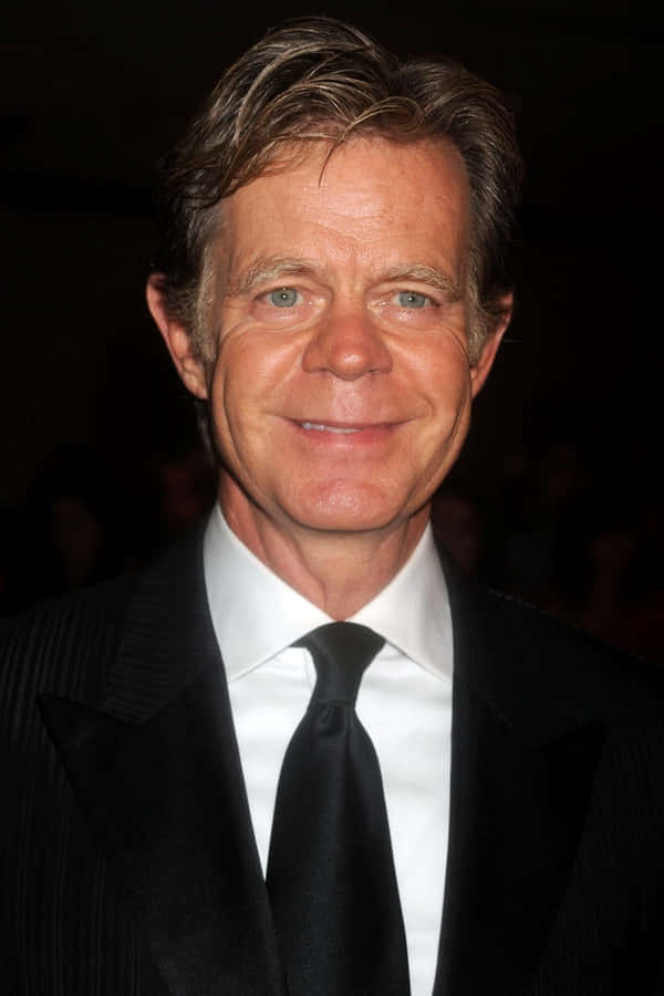 William H. Macy Smiling At An Event Wallpaper