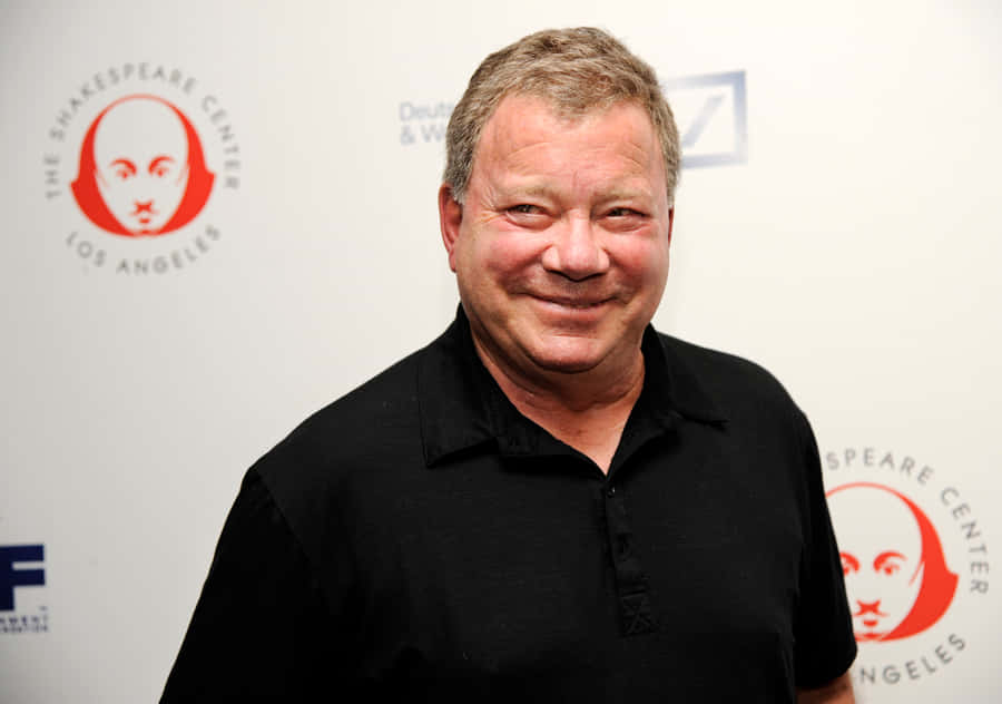 Download free William Shatner Smiling In A Black Suit With A Blue Shirt ...