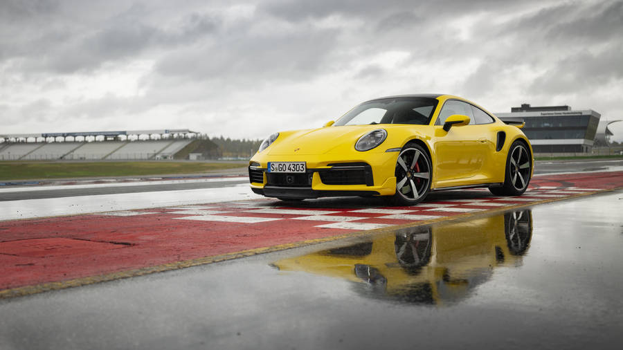 Yellow Porsche 911 In Empty Stadium Wallpaper