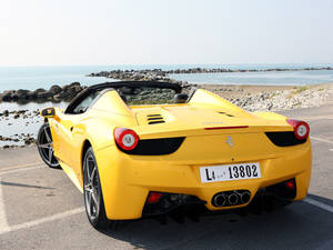 4k Ferrari Yellow Near Beach Wallpaper