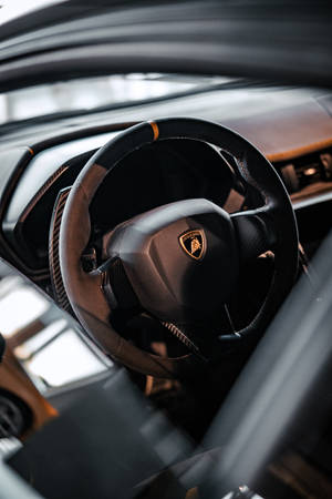 4k Lamborghini Logo On Steering Wheel Wallpaper