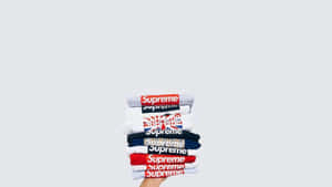 4k Supreme With Folded Shirts Wallpaper