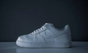 4k White Nike Air Shoe On Black Wallpaper