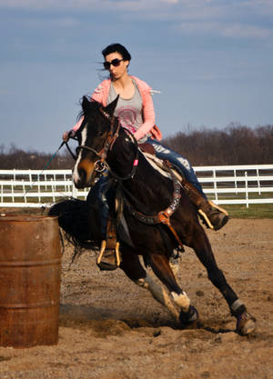 A Barrel Racer In Action Wallpaper