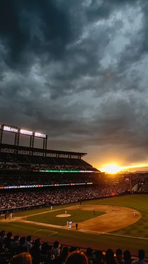 A Baseball Game With A Dark Sky And Clouds Wallpaper