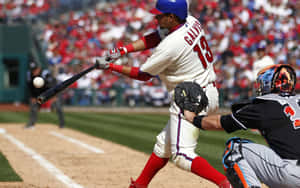 A Baseball Player Swinging A Bat Wallpaper