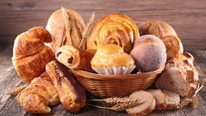 A Basket Overloaded With Artisan Breads Wallpaper