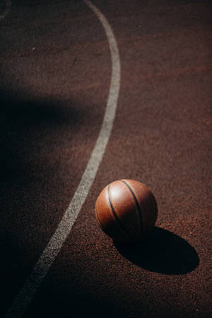 A Basketball Ball On A Court Wallpaper
