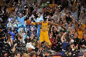 A Basketball Player Is Celebrating With Confetti Wallpaper