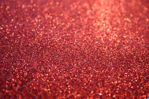A Beautiful, Eye-catching Glimmer Of Orange Glitter Wallpaper