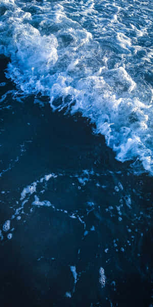 A Beautiful Ocean Sunset Mirrored In The Surface Of A Cell Phone Wallpaper