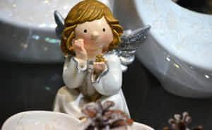 A Beautiful Vintage Angel Bathed In Golden Light Wallpaper