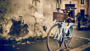 A Bicycle Parked On A Sidewalk Wallpaper