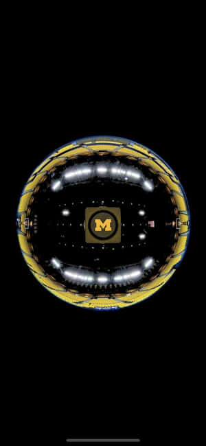 A Black And Gold Sphere With A Yellow Rim Wallpaper