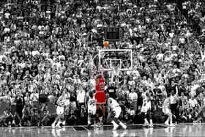 A Black And White Photo Of A Basketball Game Wallpaper