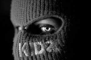 A Black And White Photo Of A Person Wearing A Knitted Mask Wallpaper