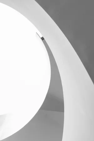 A Black And White Photo Of A Spiral Staircase Wallpaper