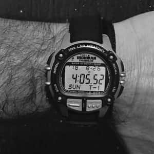 A Black And White Photo Of A Watch On A Person's Wrist Wallpaper