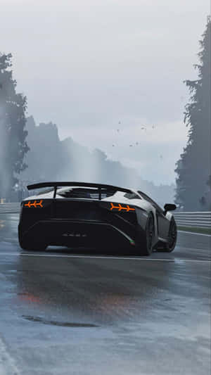 A Black Lamborghini Shines In The Sun, Ready To Hit The Roads In Style Wallpaper