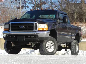 A Black Truck Is Parked In The Snow Wallpaper