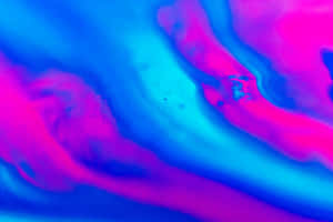 A Blue And Pink Liquid Is Floating In The Air Wallpaper
