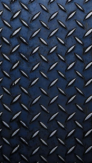 A Blue Metal Plate With Diamonds On It Wallpaper