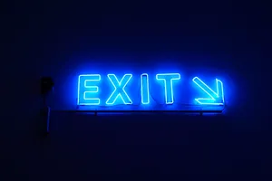 A Blue Neon Sign With The Word Exit Wallpaper