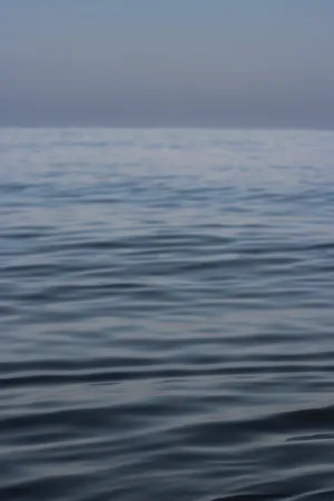 A Blue Ocean With A Boat In The Water Wallpaper