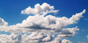 A Blue Sky With White Clouds Wallpaper