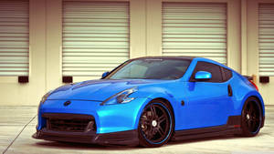 A Blue Sports Car Parked In Front Of A Garage Wallpaper